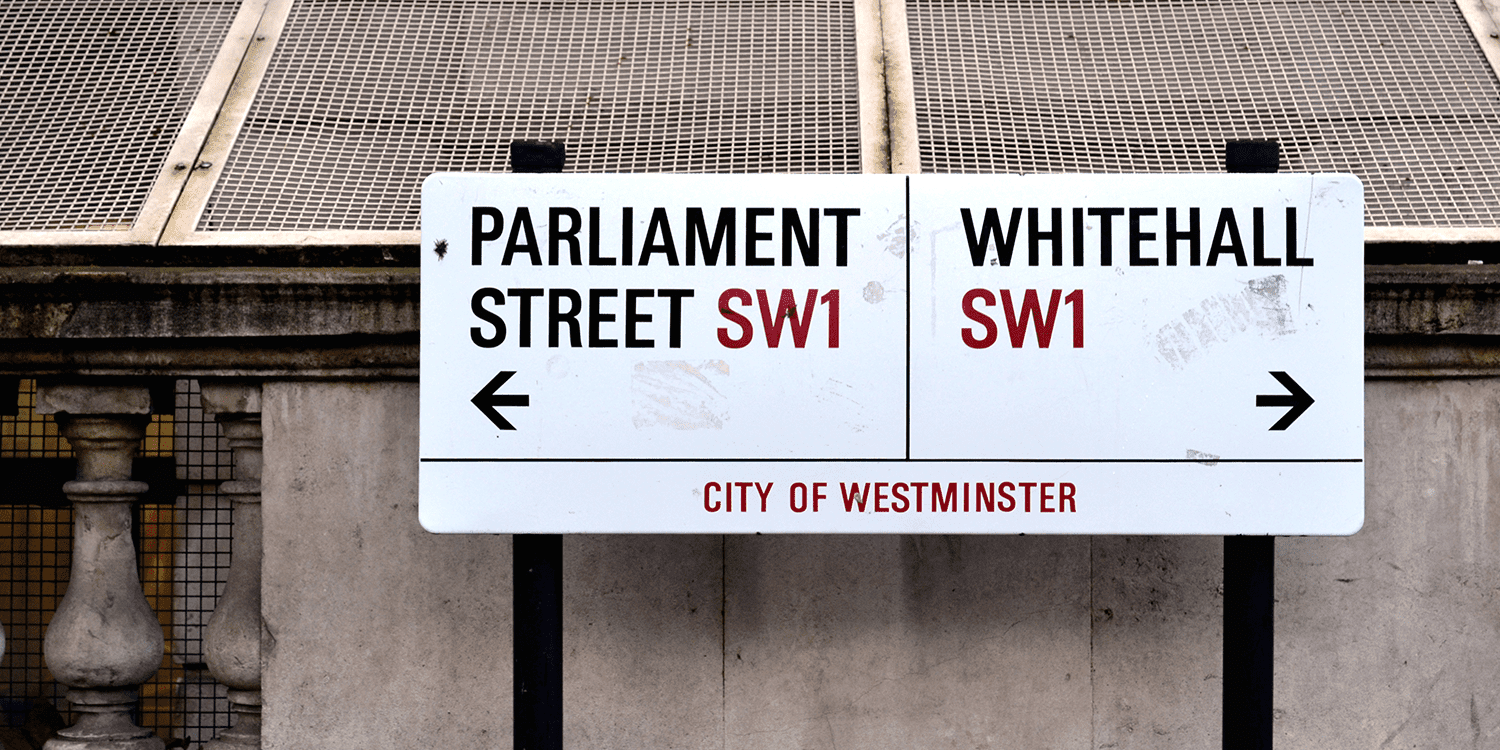 Image of a white street sign in London, printed with the words "Parliament Street Sw1, Whitehall SW1, City of Westminster", representing our optional registered office service in London.