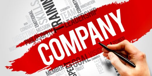 Hand underlining the word 'Company' surrounded by business-related terms like leadership, skills, and training
