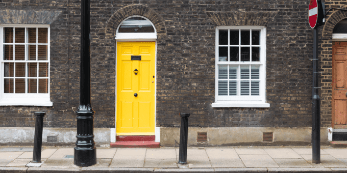 Photograph of a Georgian building with a yellow door, providing an example of the type of physical address you can use as a service address or registered office.