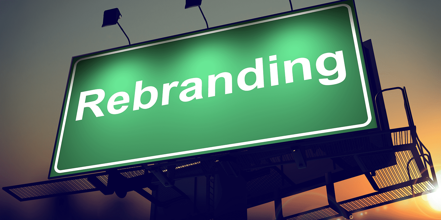 Illuminated sign with the word 'Rebranding' in white text against a green background, illustrating the concept of changing a company name.