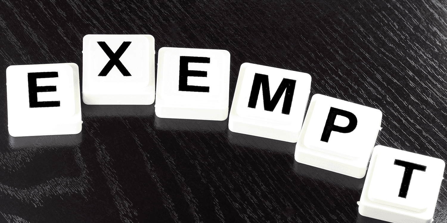 White scrabble tiles that spell the word 'exempt', representing the process of applying for 'limited' word exemption for a company name