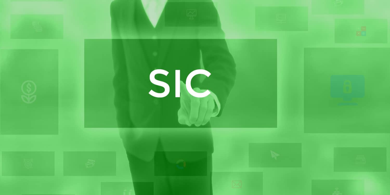 Business person selecting the word 'SIC' as displayed on a full size electronic screen.