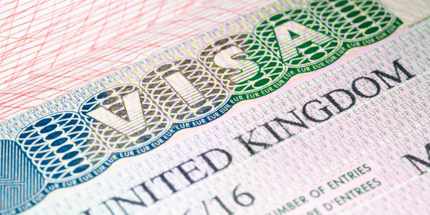 Image of a page of a passport with a UK visa attached.