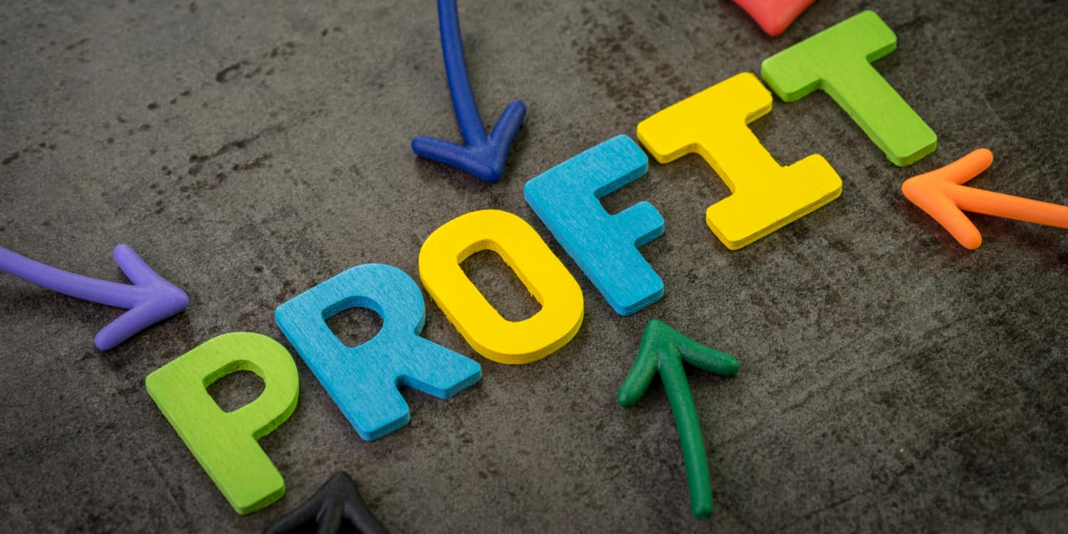 Multi-coloured magnetic letters on a blackboard displaying the word 'PROFIT', illustrating the concept of distributing company profits.