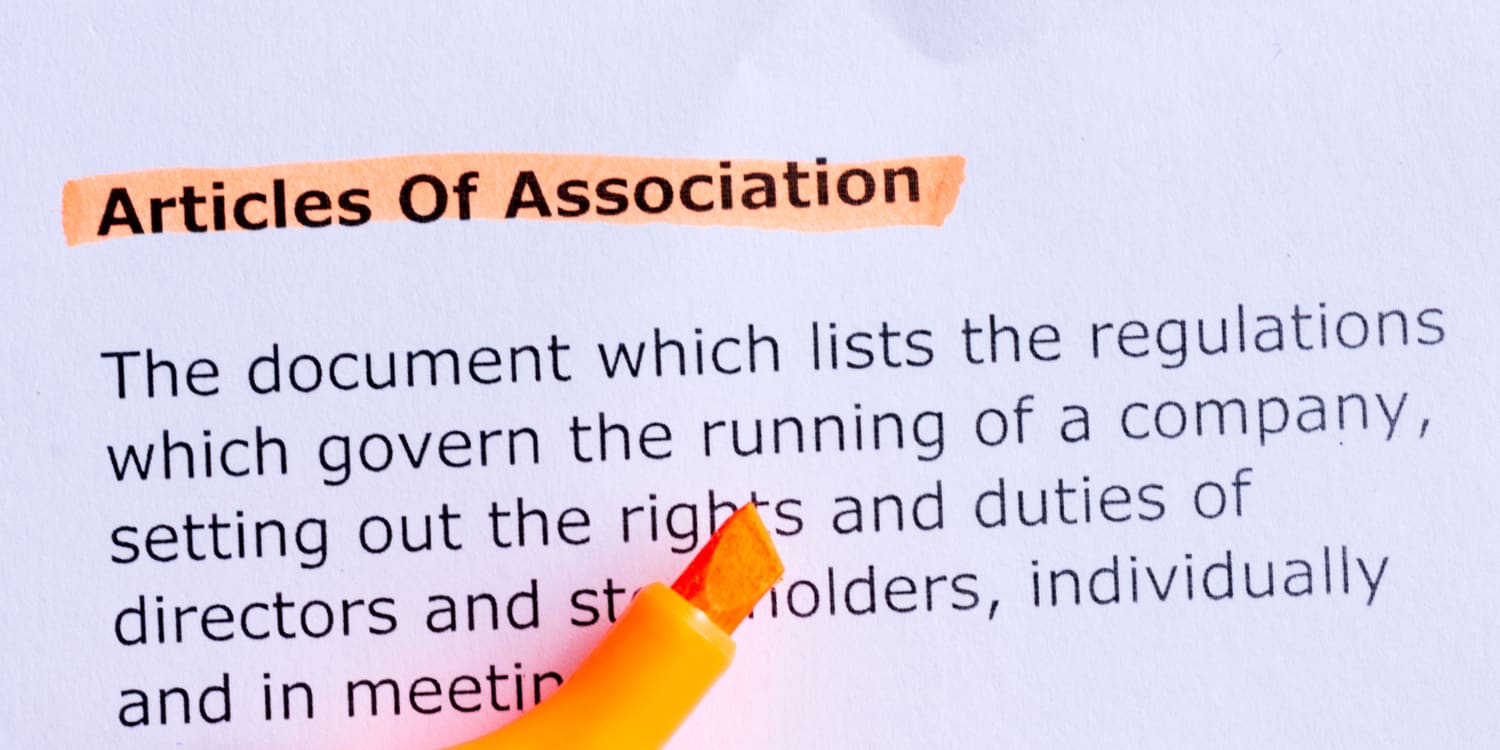 articles of association word highlighted with orange highlighter pen on the white paper