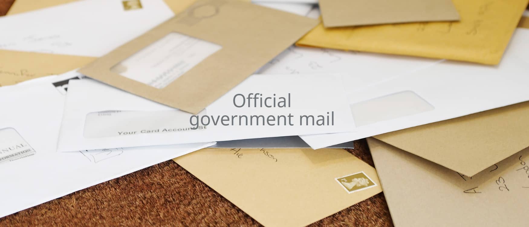A pile of mail on a doormat with the heading 'official government mail'