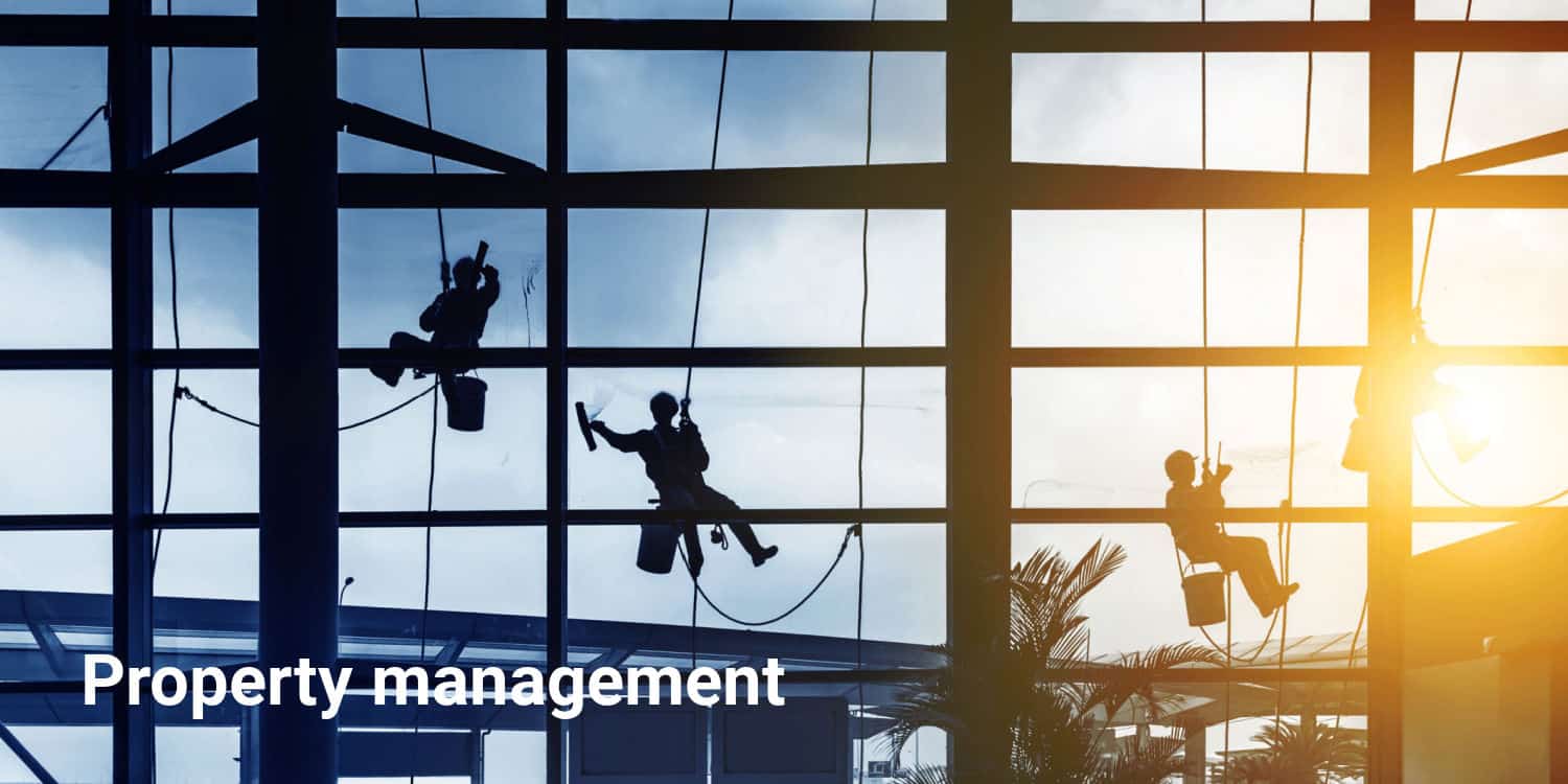 Image of workers washing windows on a high rise residentail property with a headline of Property Management.