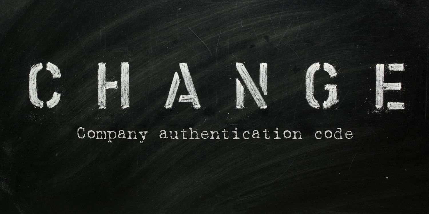 The words 'CHANGE Company authentication code' in stencil letters on a blackboard.