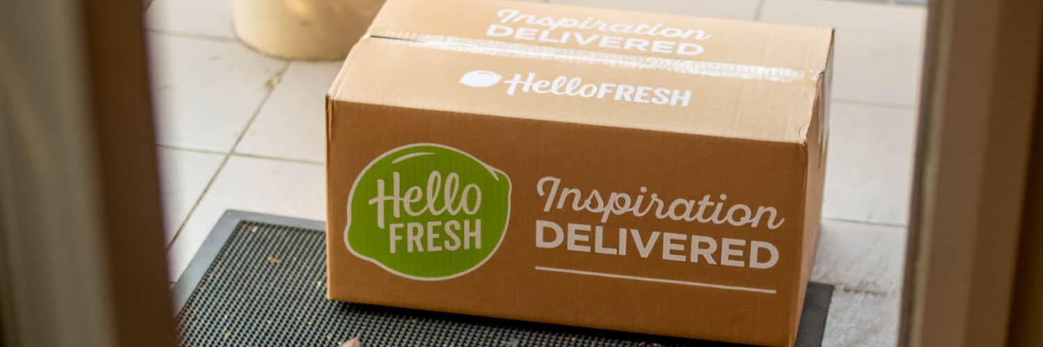 Image of Hello Fresh meal kit delivery in brown cardboard box - sitting on doorstep. Illustrating concept of subscription boxes.