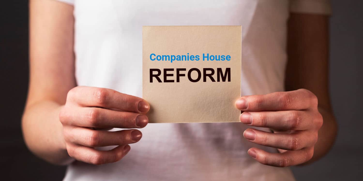 Female hands holding a card with the words 'Companies House REFORM' in blue and black font colours.
