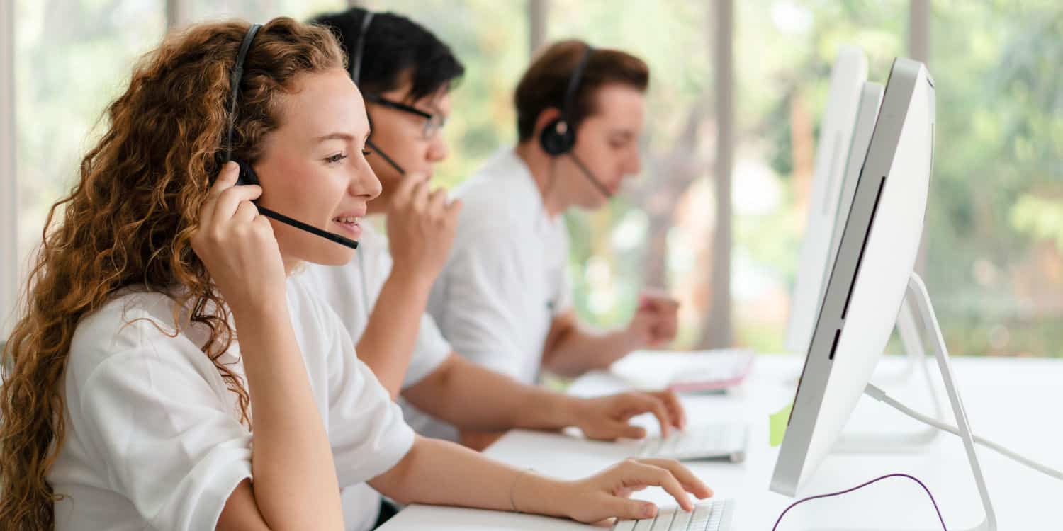 Outsourced customer service agents handling calls in call centre.