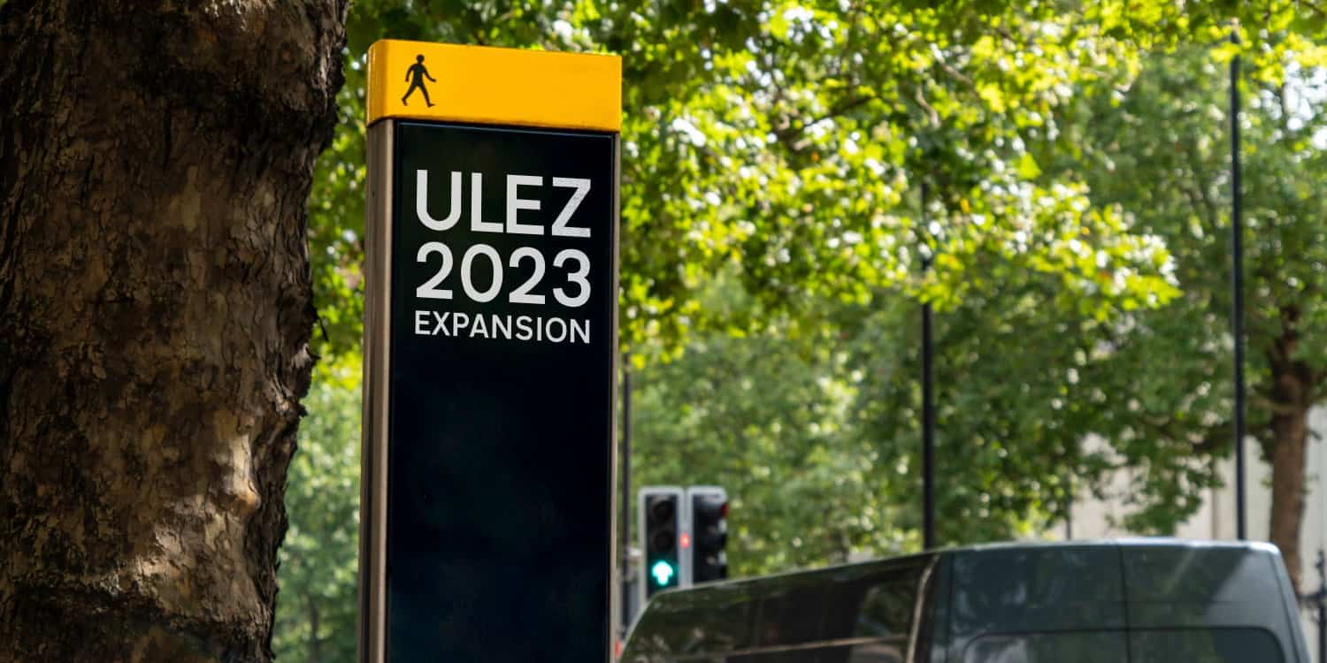 'ULEZ 2023 Expansion' on a signpost in London.