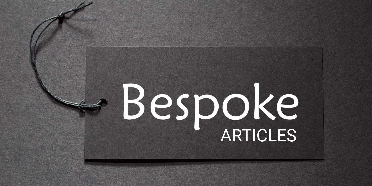 'Bespoke articles' text on a black tag on black paper background.