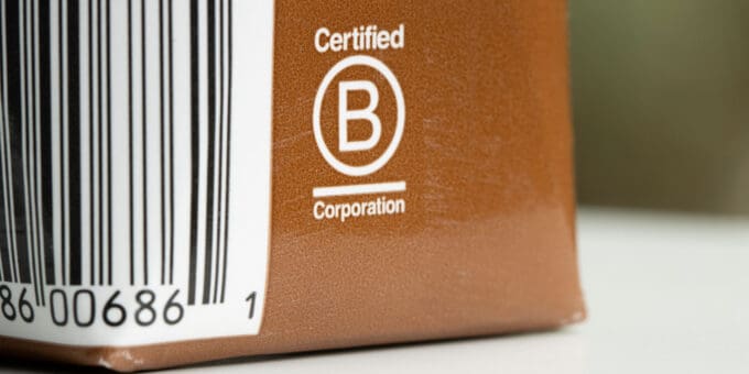 Certified B Corporation label on a brown coffee carton.