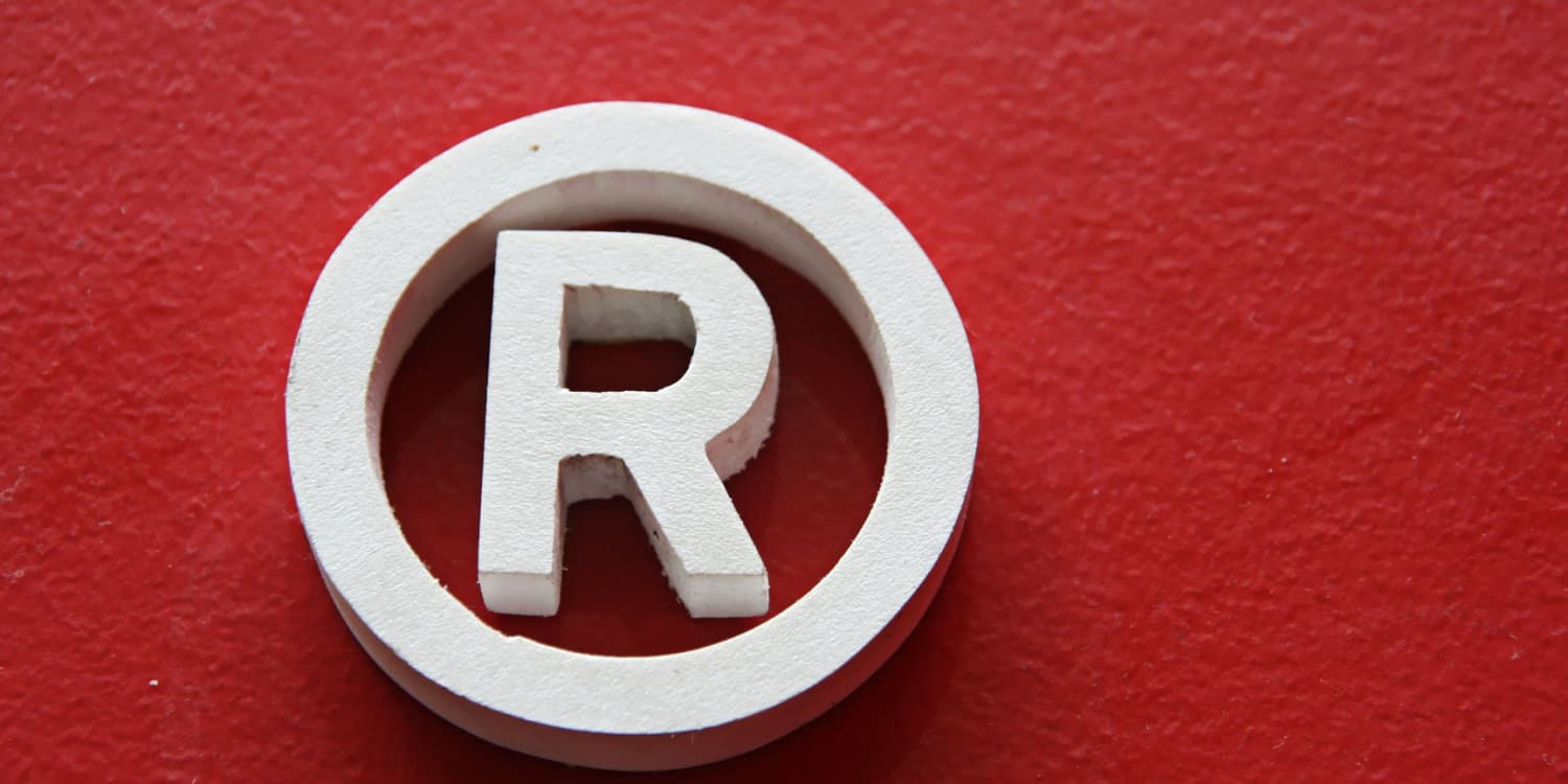 White registered trade mark symbol against a red background.