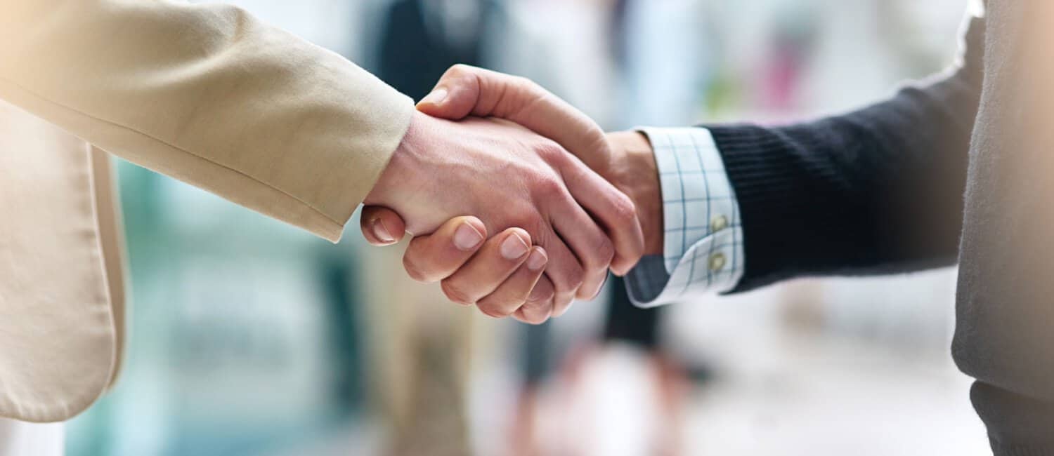 Two businessmen shaking hands illustrating the concept of trust.