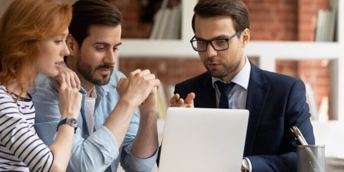 Male company expert in business suit consulting with a married couple at their home on how to remove a residential address from the Companies House register.