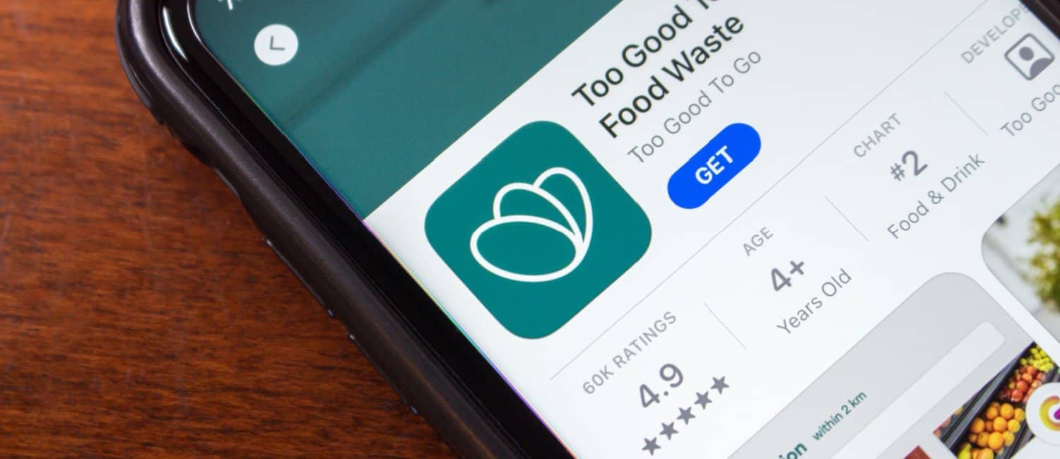 An image of a mobile phone displaying the Too Good to Go app, a marketplace that helps businesses reduce food waste