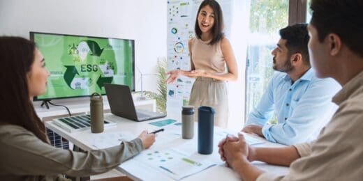 A group of professionals in a business meeting, presenting ideas about ESG and researching sustainability grants for small businesses