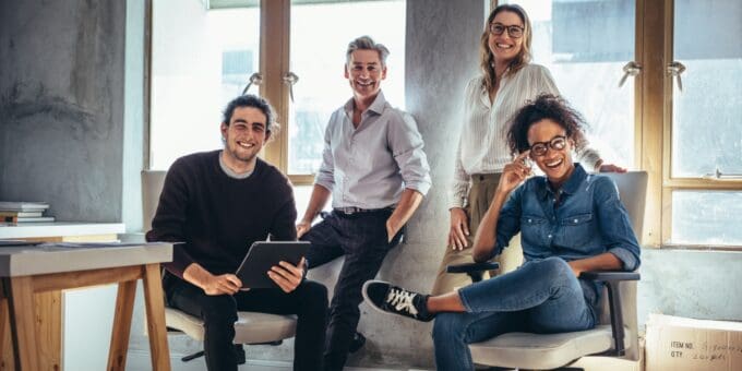 Portrait of successful group of people working at online web store. Men and women at ecommerce business office.
