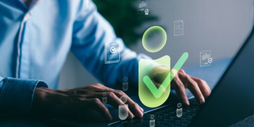 Person typing on a laptop with digital verification icons floating on screen, representing the process of Companies House identity verification for UK directors and PSCs