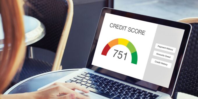 Person checking credit score on laptop - concept of starting a business with bad credit